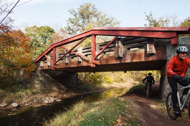 Cyclists navigate a low bridge along the canal path in Delaware Canal State Park near Washington Crossing, Pa. The canal path, the central feature of the Delaware Canal State Park, runs 60 miles parallel to the Delaware River in southeastern Pennsylvania. AP