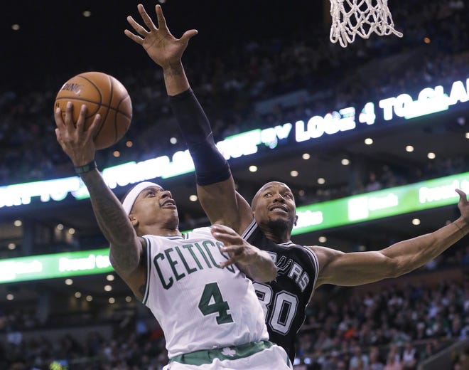 Boston Celtics guard Isaiah Thomas takes a shot as San Antonio Spurs forward David West tries to block him in the third quarter Sunday in Boston. The Spurs won 95-87. Steven Senne/THE ASSOCIATED PRESS