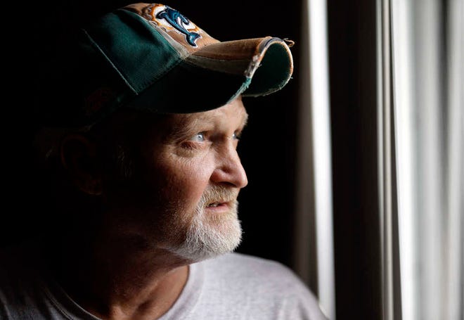 In this Oct. 28, 2015 photo, John Davis poses for photos at his home in Port Charlotte, Fla. Davis, a 49-year-old construction worker unemployed because of health problems, is among those who cannot get health insurance through HealthCare.gov because the law prevents people below the poverty line from using the insurance exchanges. So the private insurance alternative is closed to them, even as their states refuse to expand public coverage.