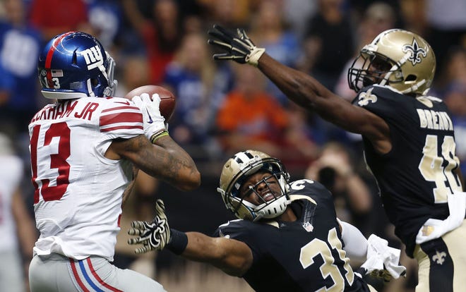 Giants' Odell Beckham (13) pulls in a touchdown pass in front of Saints' Jairus Byrd (31) and Delvin Breaux (40) in the second half. The Associated Press