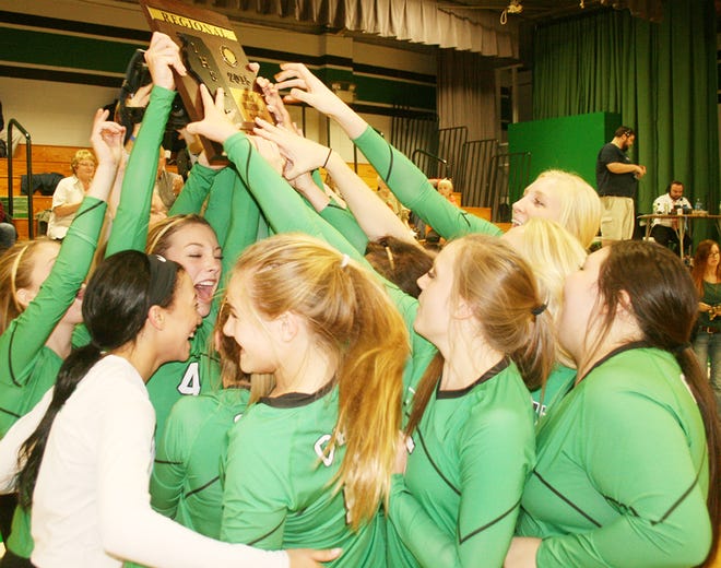 The Wethersfield volleyball team hoists the regional plaque Thursday night.