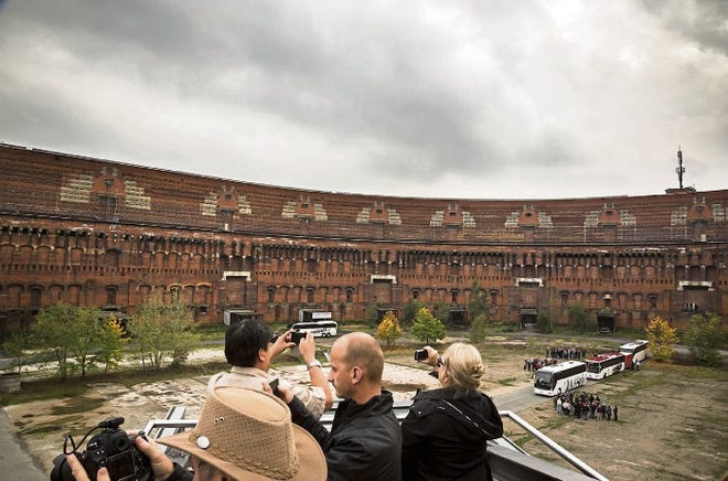 Tourists take photographs of the inner courtyard of Congress Hall on the Nazi Party rally grounds in Nuremberg, Germany.