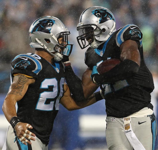 Kurt Coleman (20) and Roman Harper celebrate a play during the Carolina Panthers' 29-26 overtime victory over the Indianapolis Colts Monday night in Charlotte.