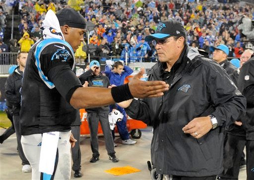 Carolina Panthers' Cam Newton, left, and Carolina Panthers head coach Ron Rivera, right, shake hands before an NFL football game in Charlotte, N.C., Monday, Nov. 2, 2015.