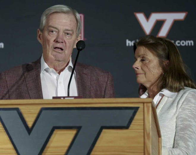 Matt Gentry The Roanoke Times via AP Virginia Tech coach Frank Beamer, with his wife, Cheryl, reacts during a news conference Monday in Blacksburg Va.