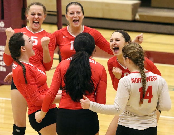 Northwest players celebrate after winning the second set during their Division II regional semifinal against Marlington on Tuesday. The Indians advanced to the regional final with a five-set victory.