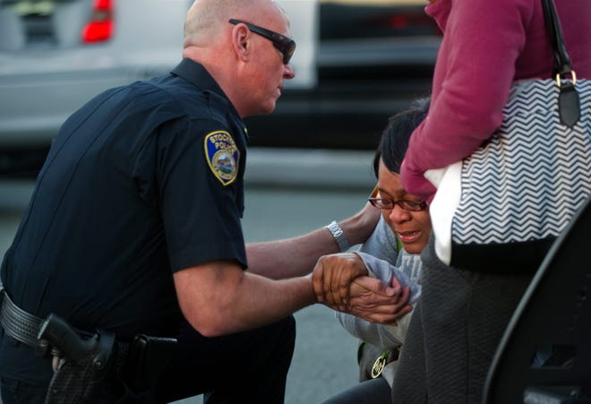 Stockton Police Lt. Toby Wills comforts Zharain Lott-Roberts after she learned that her brother was killed in a shooting Wednesday on Charleston Court near Kelley Drive in north Stockton. Grieving family members identified the victim as 44-year-old Troy Lott Jr. “I’m totally devastated,” Lott-Roberts said. “He was an outgoing, happy-go-lucky person.”  CLIFFORD OTO/THE RECORD