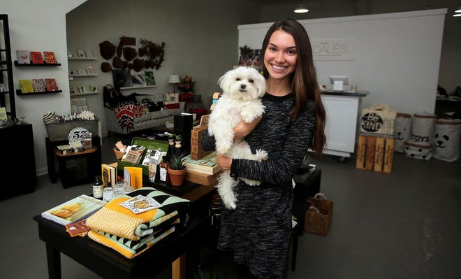 Amanda Flontek and dog Groban show off Fadales on Wednesday. The gift shop with a purpose is located at 103 North Lafayette Street in uptown Shelby.