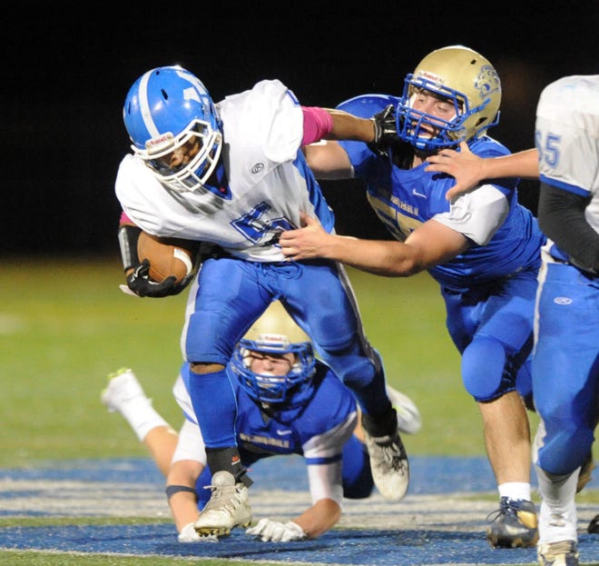 Deshaun Dias of Mashpee fights off Jake Catarius of St. John Paul II for extra yardage in their game in October. Dias rushed for 200 yards and three touchdowns in the Falcons' win. Ron Schloerb/Cape Cod Times