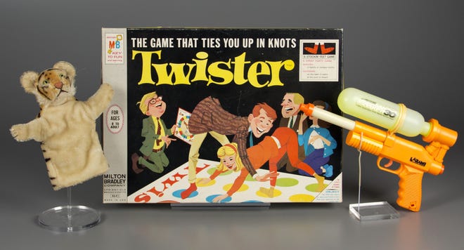 From left, a puppet, the game of Twister and a Super Soaker are among the 2015 inductees for the Strong's National Toy Hall of Fame. The Associated Press