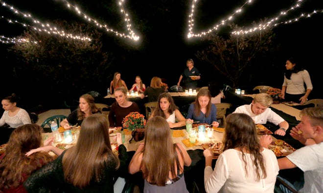 German and American students eat during a Thanksgiving dinner for the exchange students on Thursday in Gainesville.