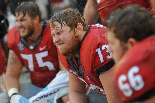 Georgia guard Greg Pyke (73) and Georgia offensive tackle Kolton Houston (75) react on the sidelines during the second half of an NCAA college football game between Georgia and Alabama on Saturday, Oct. 3, 2015, at Sanford Stadium in Athens, Ga. (AJ Reynolds/Staff, @ajreynoldsphoto)