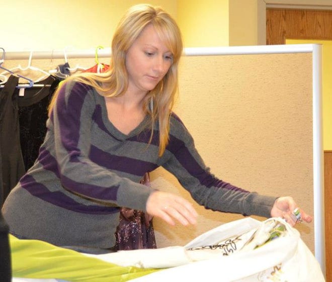Karmen Case sorts through donated dresses for a previous year's event. Courtesy Photo
