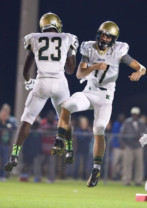 Kinston wide receiver Ronnie Simmons (23) and quarterback Thomas Vermillion (17) celebrate after a touchdown Friday against the Chargers at Ayden-Grifton High School