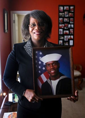 Brittany Randolph/The StarSheliah Webber holds a photo of her son, Travis McDowell, in her home on Jenny Drive in Shelby. McDowell is currently in the Air Force Reserves and stationed in Charlotte.
