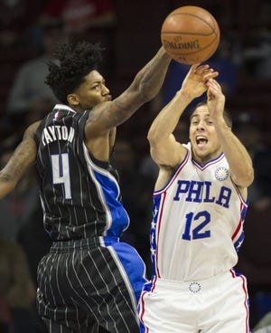 The Magic's Elfrid Payton (4) deflects the ball away from Sixers rookie T.J. McConnell (12) on Saturday, Nov. 7, 2015, at the Wells Fargo Center.