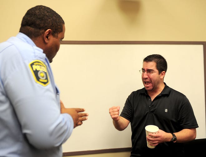 Columbia Police community service aid John Hayes, left, listens as Columbia Police Det. Andy Muscato portrays a drunken man who is causing a disturbance at his stepfather’s home Friday. The scene was one of several 10-minute scenarios portrayed for about 50 law enforcement officers at the Crisis Intervention Team training at the Boone County Sheriff’s Department.