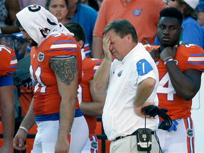 Florida head coach Jim McElwain wipes his forehead during the second half of an NCAA college football game against Vanderbilt, Saturday, Nov. 7, 2015, in Gainesville, Fla. Florida won 9-7.