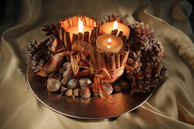 Pillar candles wrapped with cinnamon sticks and surrounded by acorns and pine cones make an easy autumn centerpiece.

 	 	

The Providence Journal/Sandor Bodo