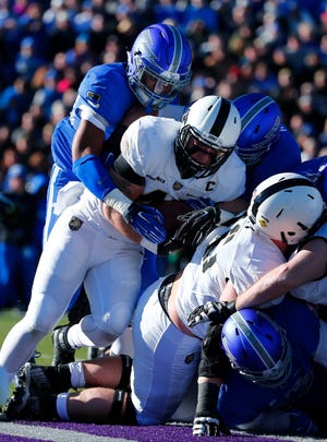 Army running back Matt Giachinta (40) is stopped by the Air Force defense during the first half of Saturday's game in Colorado. The Black Knights came into the game averaging 274 yards rushing, but they were held to 124 yards on 44 carries by Air Force. The Associated Press