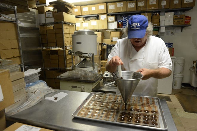 Tom Block makes chocolates at Pierre's Chocolates in New Hope. Pierre's was one of six U.S. chocolatiers invited to explore cacao fields, dairy farms and sugar cane plantations in Ecuador.