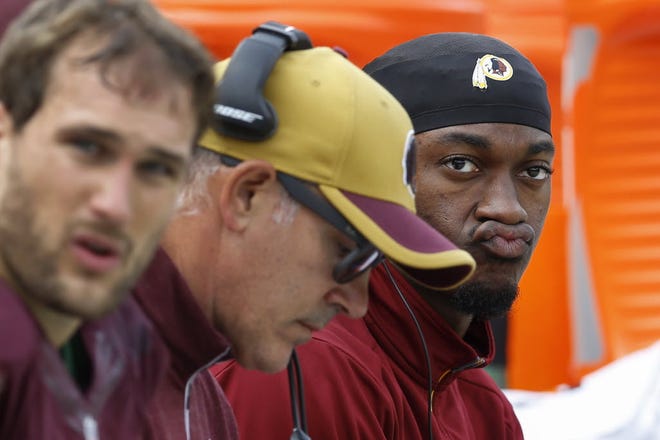 Washington quarterback Robert Griffin III, right, the second pick in the 2012 NFL Draft, is now a backup to Kirk Cousins.