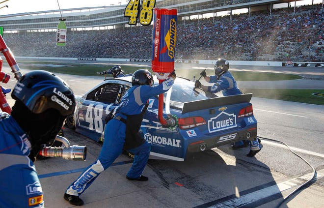 Jimmie Johnson (48) pits during the NASCAR Sprint Cup Series auto race at Texas Motor Speedway in Fort Worth, Texas, Sunday, Nov. 8, 2015. (AP Photo/Ralph Lauer)