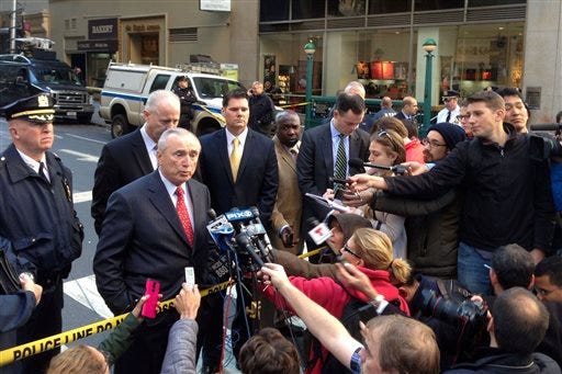 New York City Police Commissioner William Bratton, second left, talks to the press about a shooting at 35th Street and Eighth Avenue, Monday, Nov. 9, 2015, in New York. One person was killed and two others were taken to a hospital in serious condition, police said. -AP Photo/Mark Lennihan