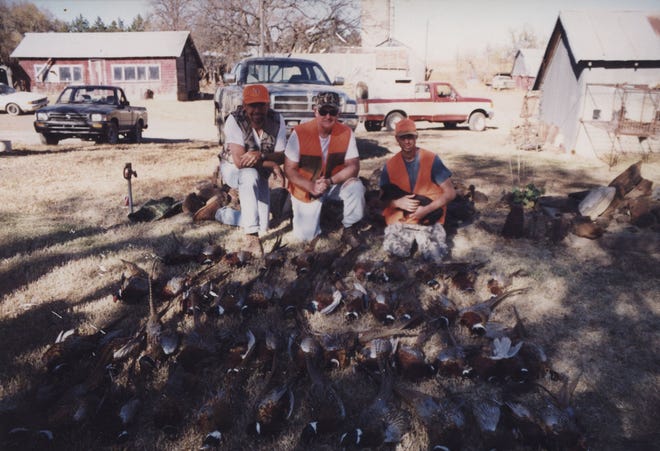 After a fruitful day of hunting in 2000, Rocky Chisholm, of the Los Angeles area, left, Daryl Jensen, Olympia, Wash., and Brent Laas, pose in front of pheasants they bagged on land Laas farms in western Salina County. Jensen is Laas’ include and Chisholm is a family friend. courtesy photo