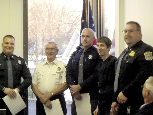 Scott Bogard, Ken Stutzman and Kyle Sherwood received Meritorious Life Saving Awards on Monday from Bronson Police Chief Stephen Johnson, for efforts to successfully revive Logan Roberts in September.