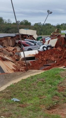 A 400-footlong section of an IHOP parking lot in Meridian, Miss., collapsed Saturday, swallowing at least 12 vehicles. (CNN photo) 
 A 400-footlong section of an IHOP parking lot in Meridian, Miss., collapsed Saturday, swallowing at least 12 vehicles. (CNN photo) 
 A 400-footlong section of an IHOP parking lot in Meridian, Miss., collapsed late Saturday, swallowing at least 12 vehicles. (CNN photo)