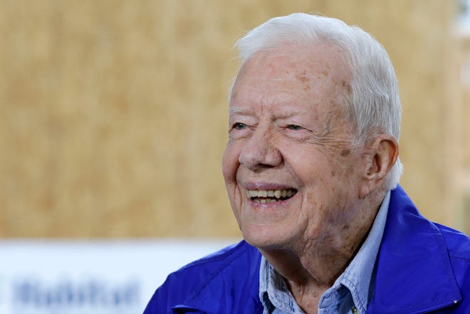 In this Nov. 1, 2015 photo, former President Jimmy Carter is interviewed at a Habitat for Humanity project site in Memphis, Tenn. Carter said it's too soon to tell whether treatment he received for his brain cancer has been effective, but that he hasn't been uncomfortable or ill while receiving rounds of immune-boosting drugs. (AP Photo/Mark Humphrey)