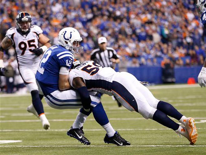 Indianapolis Colts' Andrew Luck (12) is tackled by Denver Broncos' Danny Trevathan (59) during the second half of an NFL football game, Sunday, Nov. 8, 2015, Indianapolis.