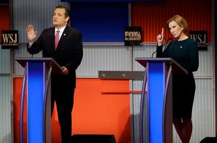 Ted Cruz speaks as Carly Fiorina tries to make a comment during a Republican presidential debate Tuesday at the Milwaukee Theatre in Milwaukee. AP