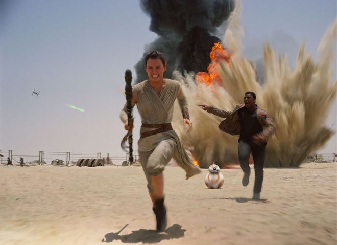 This photo provided by Disney shows Daisey Ridley as Rey, left, and John Boyega as Finn, in a scene from the new film, "Star Wars: The Force Awakens." Daniel Fleetwood, a 31-year-old Texan who is suffering from cancer, had his wish granted to see the highly anticipated new “Star Wars” film on Thursday, Nov. 4. His wife Ashley celebrated on her Facebook page that Daniel saw an unfinished version of the movie thanks to the film's producers and director J.J. Abrams. The movie releases in the U.S. on Dec. 18, 2015. (Film Frame/Disney/Lucasfilm via AP)