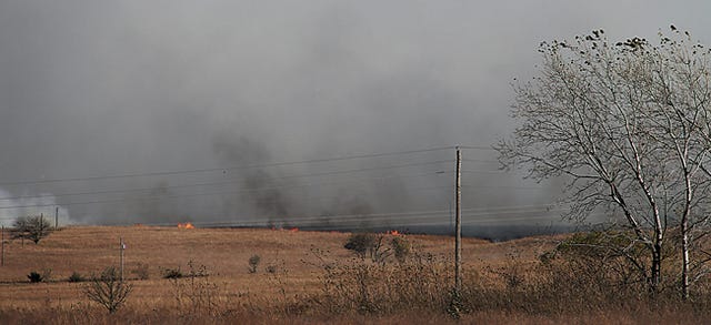 A wildfire burns east of Bartlesville Wednesday afternoon between County Road 4000 and County Road 4010. Chris Day/Examiner-Enterprise