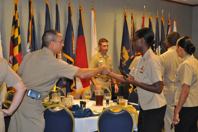 Wing 11 CMDCM Brian Porter congratulates YN2 Diana Martin at the NAS Jax Sailor of the Quarter luncheon. Ninety-four Sailors from the base were recognized and given $25 Visa gift cards, courtesy of VyStar.