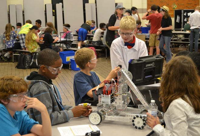 Clay County students put the final touches on their robotic displays during a science competition at Lake Asbury Elementary School in Clay County on Oct. 30. Several Fleet Readiness Center Southeast engineers volunteered as judges for the event.