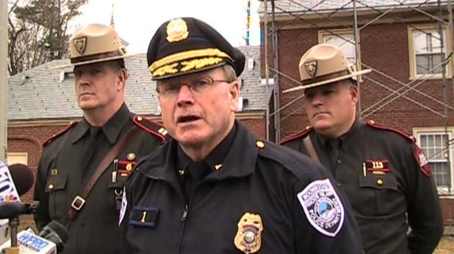Woonsocket Police Chief Thomas Carey (center) is flanked by State Police Captain Darren Delaney (left) and Lt. Steve Lefebvre (right) during a 2011 press conference. The Providence Journal, file