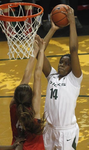 Oregon's Jillian Alleyne shoots over Fresno State's Bego Faz Davalos during the first half for two of her 26 points in the Ducks' 59-68 loss at Matt Knight Arena in Eugene on Sunday, December 21, 2014. Alleyne scored 26 points and had 16 rebounds to break the Pac 12 record for consecutive games with a double-double. (Andy Nelson/The Register-Guard)