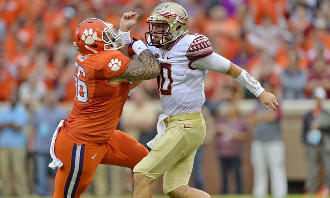 Florida State quarterback Sean Maguire, right, is pressured as he throws during last week's game against Clemson.