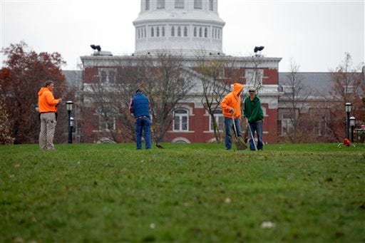 University of Missouri grounds maintenance workers begin to clean up Mel Carnahan Quad on the University of Missouri campus Wednesday, Nov.11, 2015, in Columbia, Mo. The Concerned Student 1950 activist group tent city was disassembled overnight after both the University system president and the chancellor resigned. -John Happel/Columbia Missourian via AP