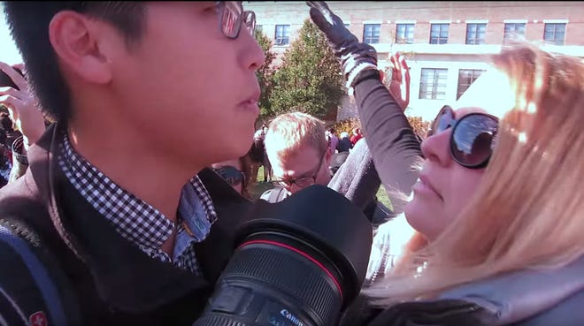 Janna Basler,  an associate director in the University of Missouri Department of Student Life, right, confronts MU student journalist Tim Tai in a still from a video posted online Monday. The Department of Student Life announced on Wednesday that Basler has been placed on administrative lead.