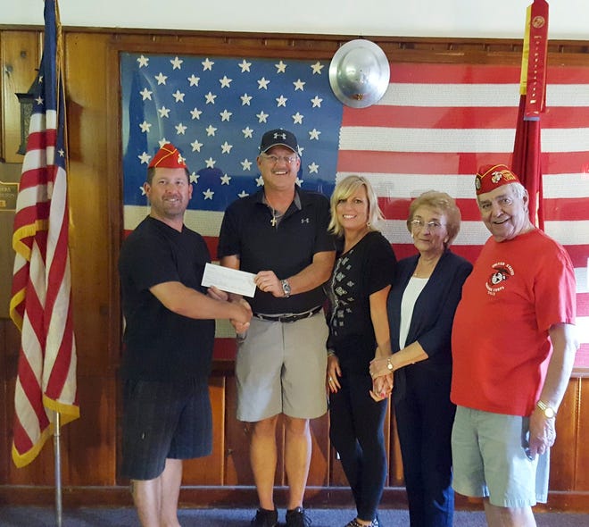 Marine Corps League members Brett Timblin and Al Woods receive a check from Jack, Dixie and JoAnn Morrison. Not pictured are Pam, Emma and Allison Morrison. Courtesy Photo