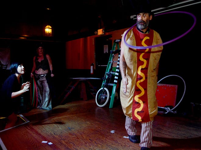Shannen Leahy, 24, throws a hula hoop at Jacek the Strange of the two-person traveling sideshow "Blue Moon Circus," as part of an interactive audience game in Market Street Pub & Cabaret on Wednesday.