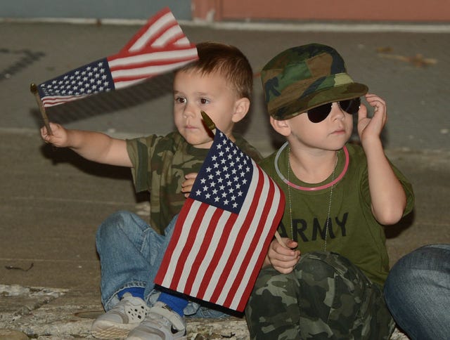 BRIAN D. SANDERFORD • TIMES RECORD
Gavyn Lester, 3, left, and his brother, Brycen, 6, watch the Van Buren Veterans Day Parade on Wednesday, Nov. 11, 2015. The brothers were attending the parade through Historic Downtown Van Buren with their parents, Justin and Amanda Lester of Alma. 
 BRIAN D. SANDERFORD • TIMES RECORD
World War II veteran Eck Rowland of Van Buren waves to spectators as he rides along with other veterans in the Van Buren Veterans Day Parade on Wednesday, Nov. 11, 2015. Rowland served in the Army from 1943-46.