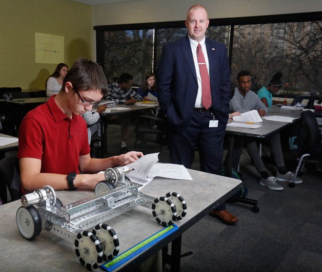 Josh Stock, 14, left, in Science class at MIT (Metro Institute of Technology) with MIT Principal Andrew K. Allmandinger, right.