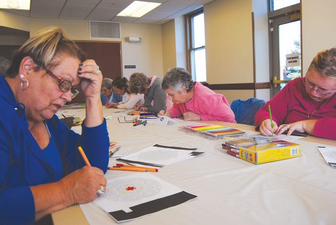 The Macomb Public Library's new adult coloring club meets at 2 p.m. the second Thursday of every month. Betty Sperry, left, says coloring helps her relieve stress.