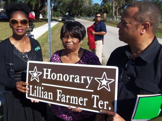 Jacki Gibson, site manger of Harvey's Fellowship Home, left, joins the daughter and son of the late Lillian Farmer, Mildred McKeever and Mickey Gillum, during a road naming ceremony on Friday.