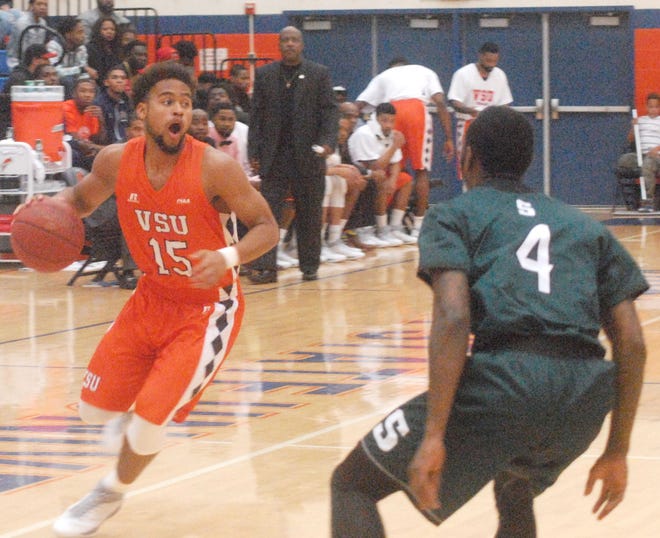 VSU's Tyler Peterson advances to the opponent's side of the court during the Trojans' first game of the 2015-16 regular season.
